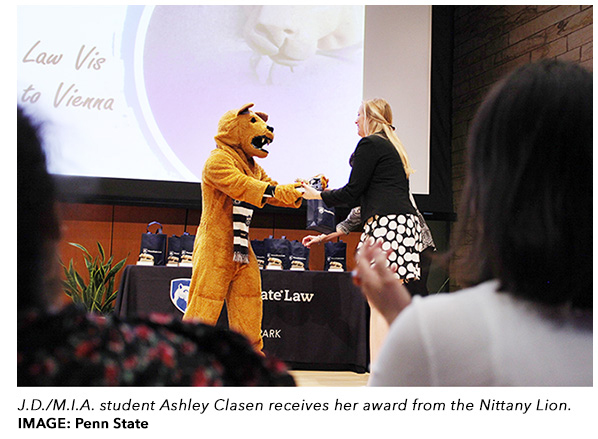 Ashley Clasen receives an award from the Lion