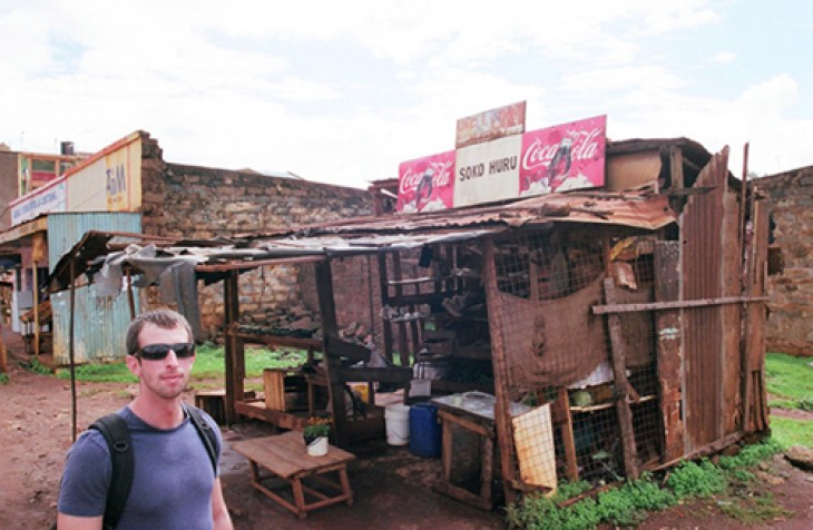 Law student Geoff Trautman '13 in front of a soko huru (private trader) shanty, Nyeri, Kenya.