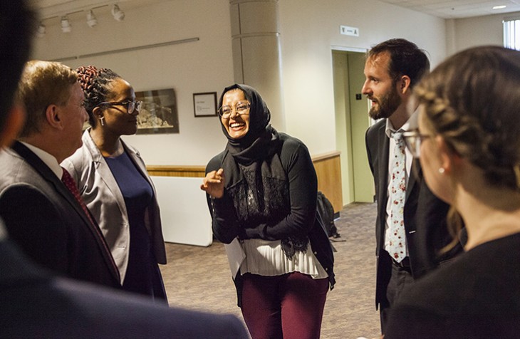 Penn State law student Shanjida Chowdhury laughs while speaking with a group at the Immigration Summit