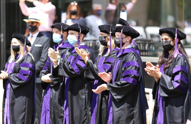 JD graduates clapping